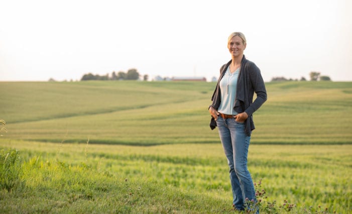 Female farmer in front of an open field