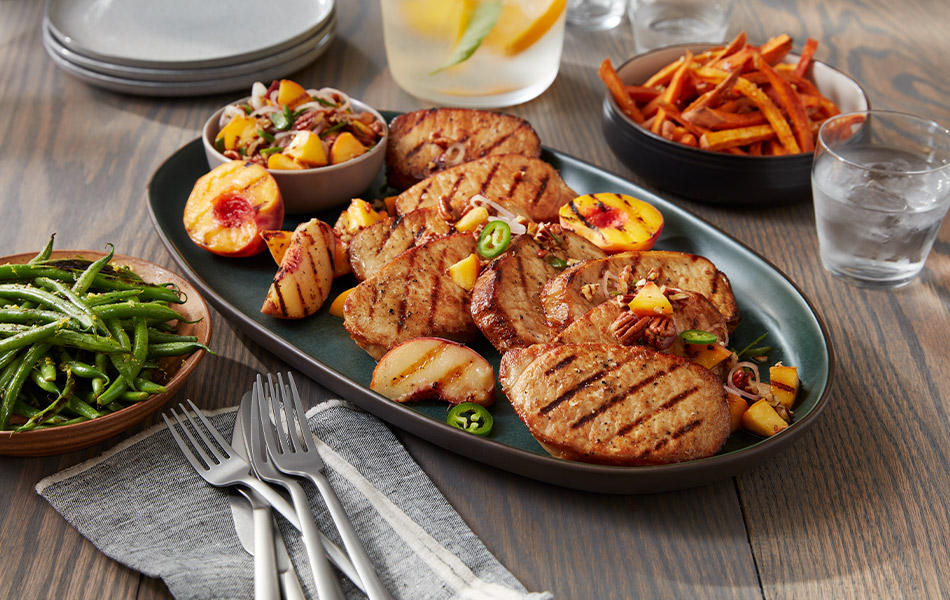 Grilled pork chops with peaches, jalapenos and sweet potato fries