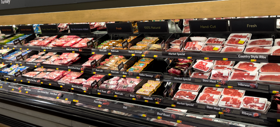 The pork and beef section of a grocery store meat case