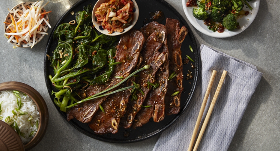Korean BBQ flanken-style short ribs with blanched spinach and kimchi